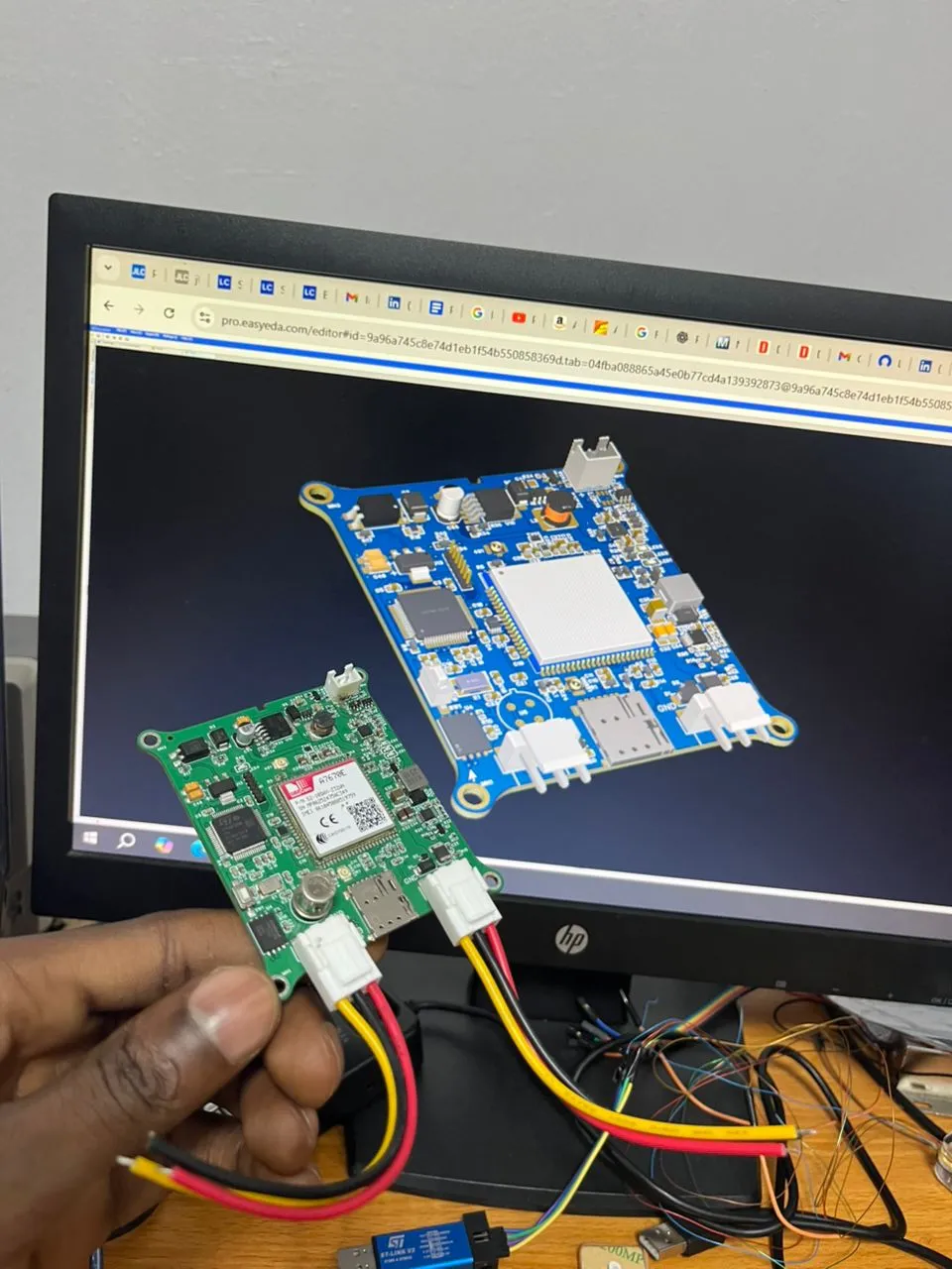 The manufactured board next to its 3D PCB design
